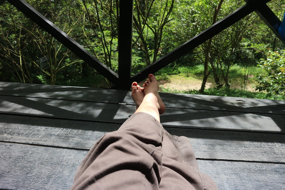 a person with their feet up in a hammock