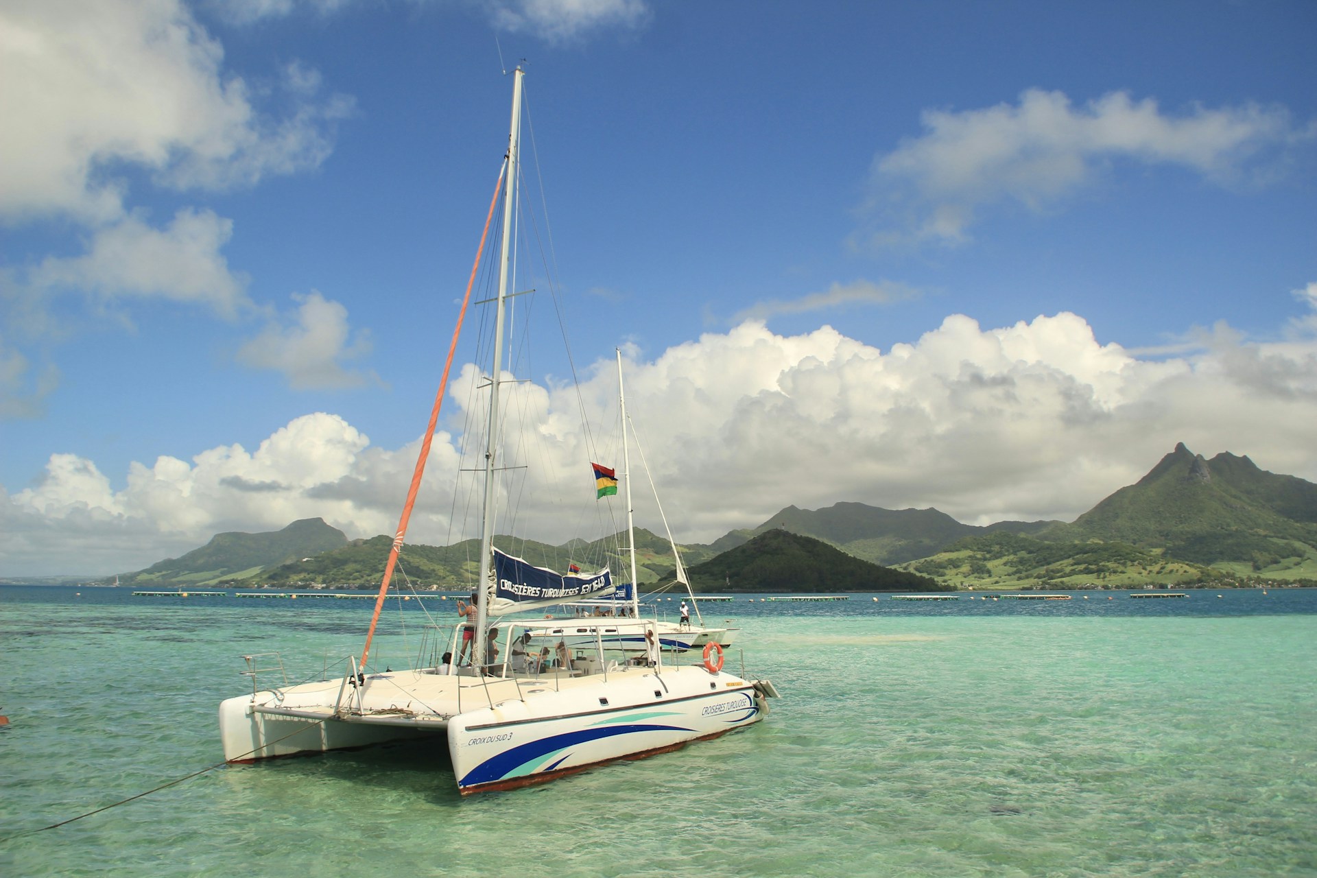 a sailboat in the water with mountains in the background