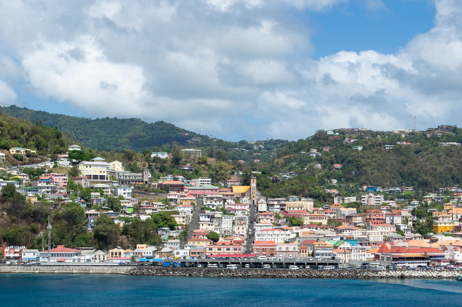 Waterfront view of a colourful Caribbean harbour town built along a hillside, St George's, Grenada