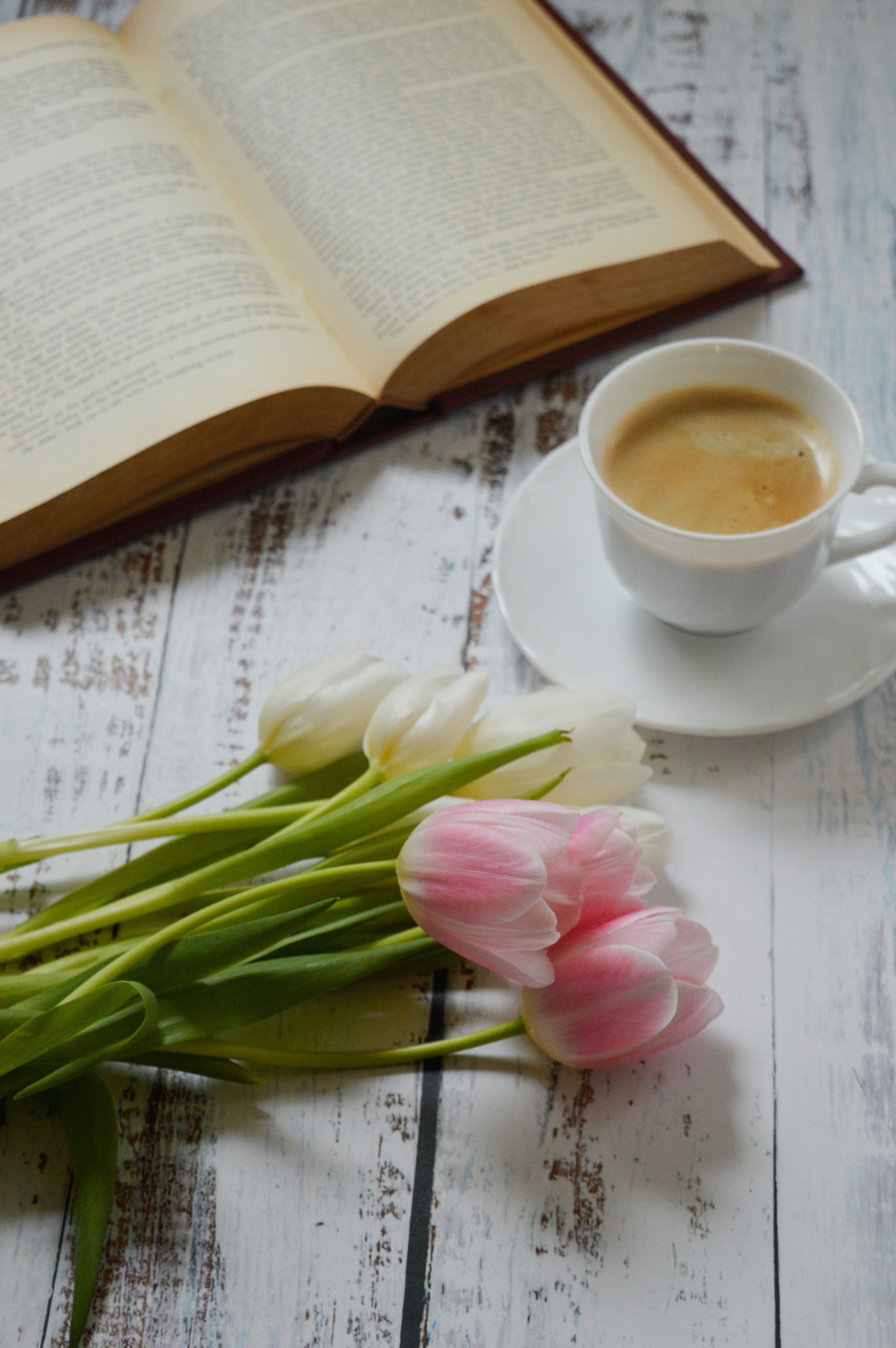 A cup of coffee and a book on a table photo Free Flower Image on Unsplash