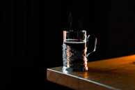A copper mug filled with a traditional beverage, steam gently rising in a cozy setting.