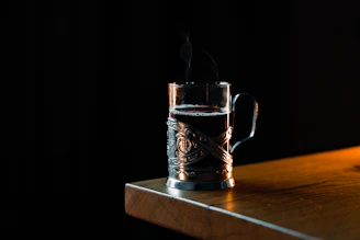 A copper mug filled with a traditional beverage, steam gently rising in a cozy setting.