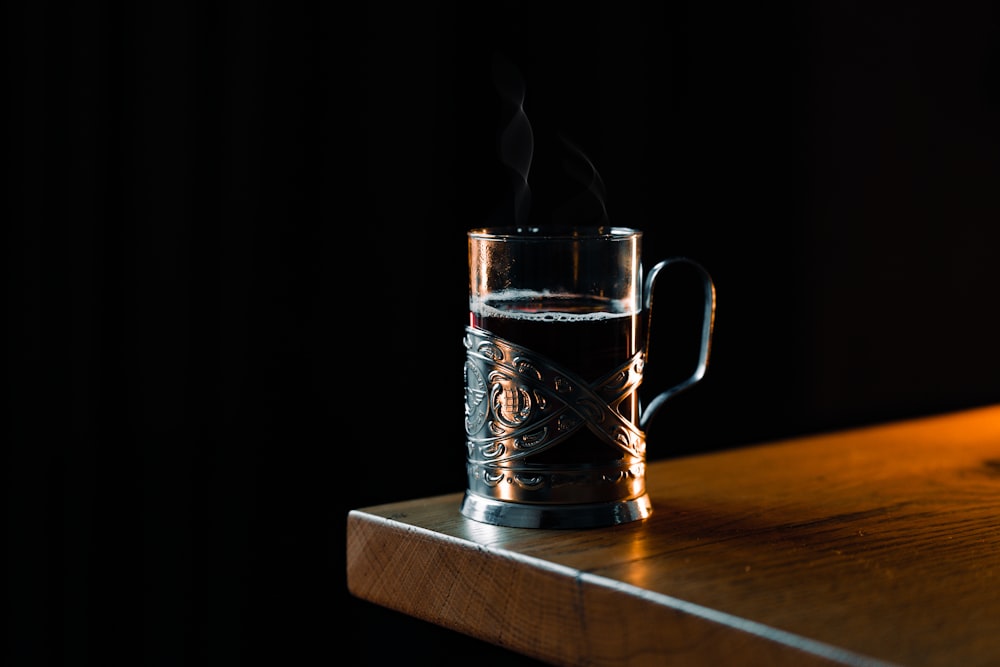 a glass mug with steam rising out of it