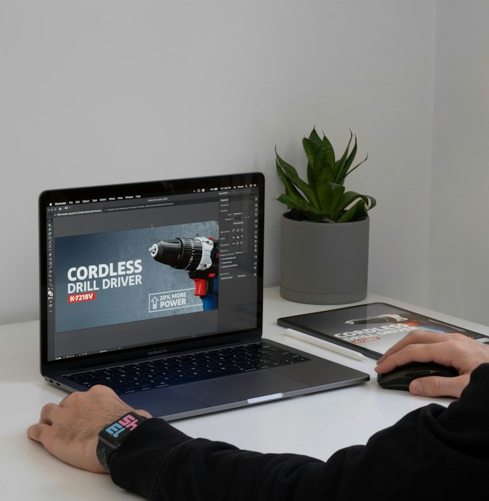 Laptop on a desk showing a website banner design