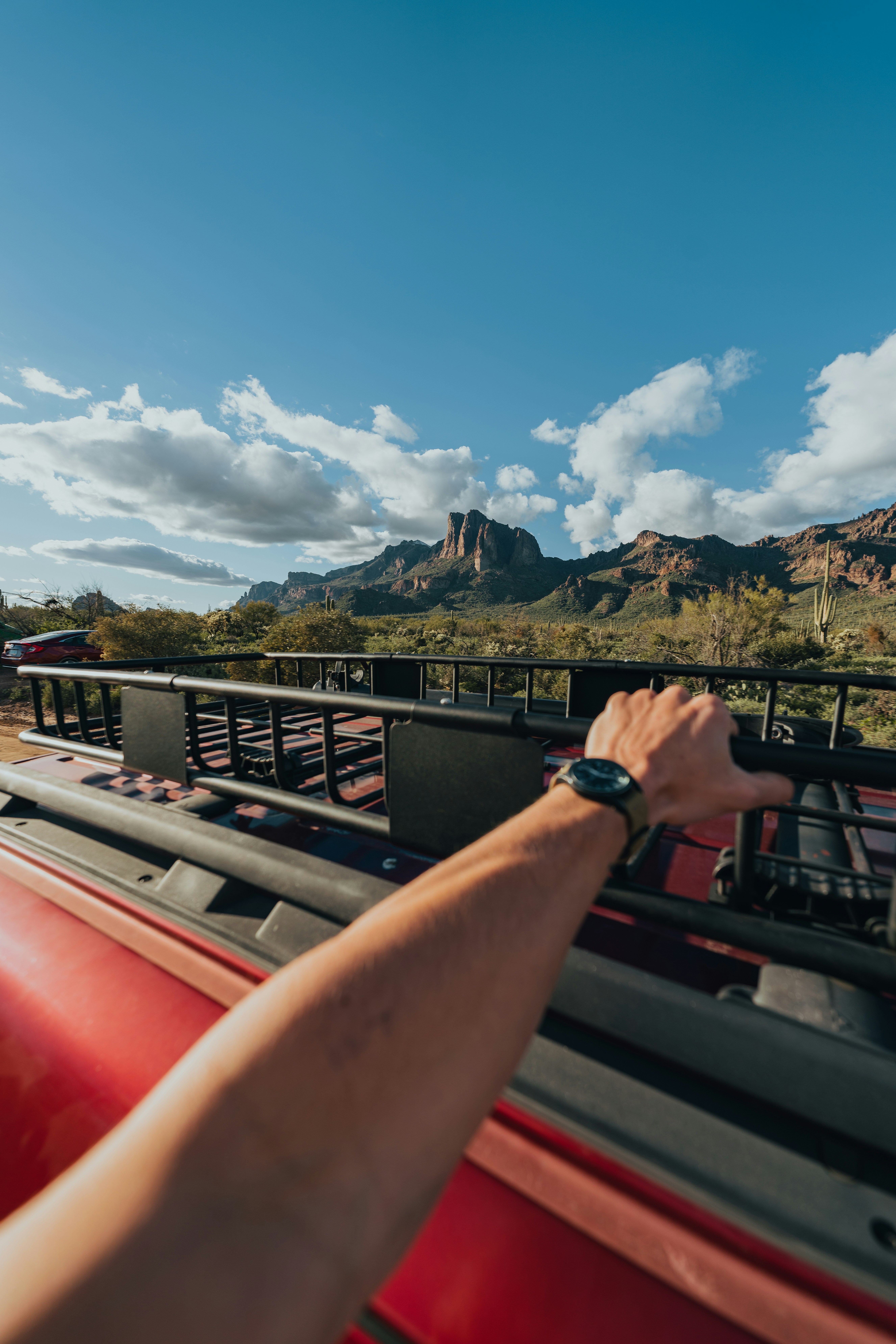 a man driving a red truck down a road