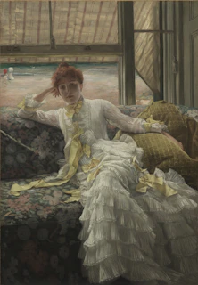 A cozy scene featuring a woman in luxurious lemon-yellow pajamas lounging on a soft cream sofa by a sunlit window.