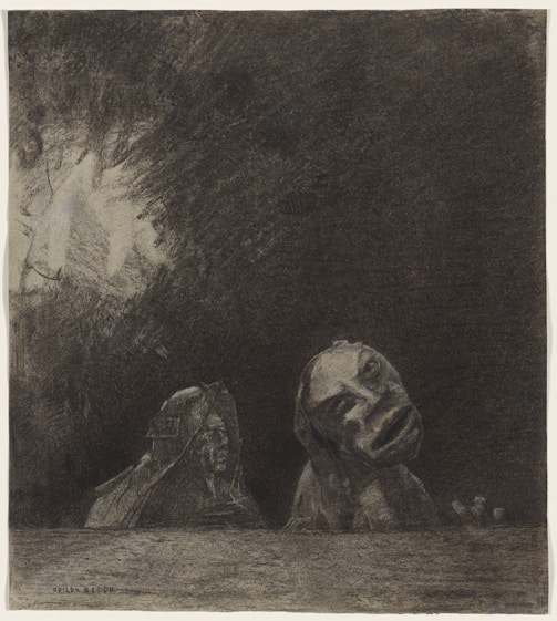 A somber black and white charcoal drawing depicting two stone-like figures, one resembling a sphinx and the other with a distorted human-like face, emerging from a textured dark background.