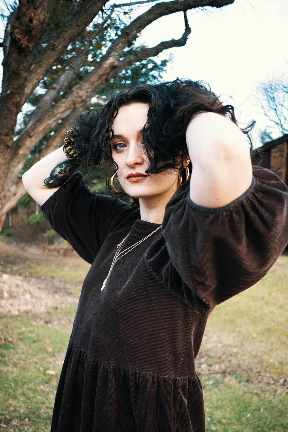 a woman in a black dress posing for a picture