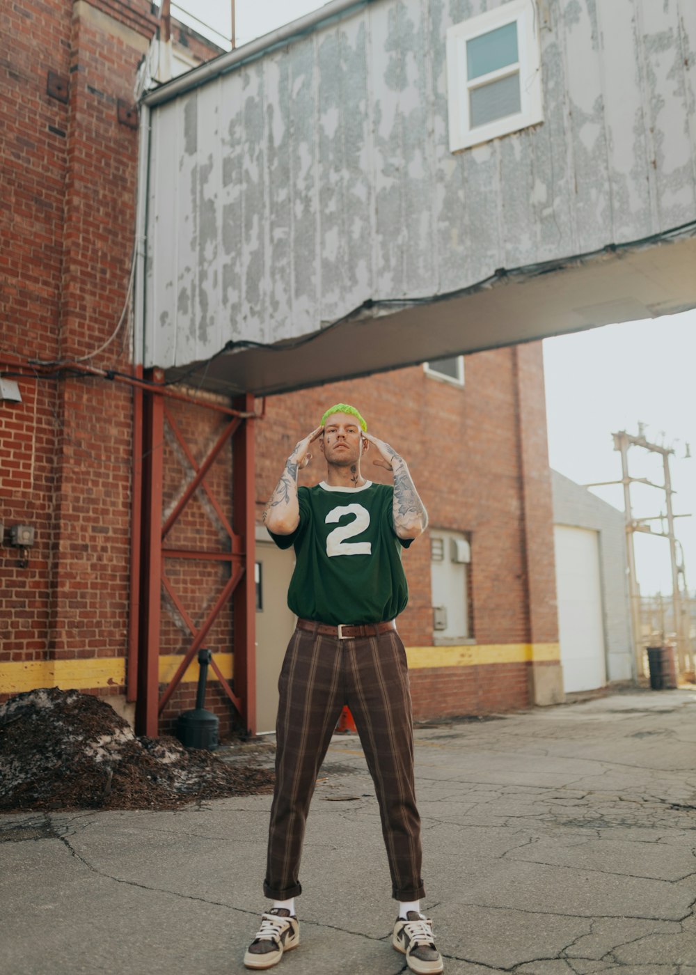 a man standing in front of a brick building