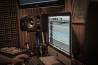 a man sitting in front of a computer monitor