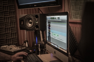 a man sitting in front of a computer monitor