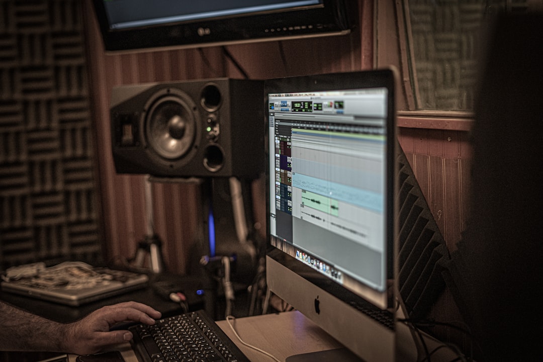 a man sitting in front of a computer monitor,