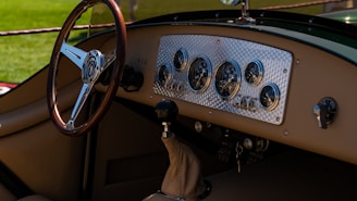 An intricate dashboard of a vintage car showing polished gauges and leather details.