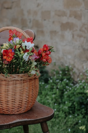 A rustic wooden basket filled with freshly picked flowers from Villa Guerrero