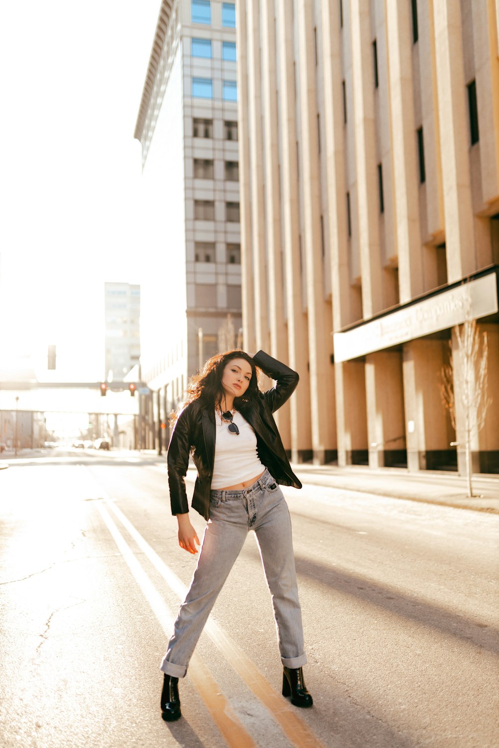 a woman standing in the middle of a street