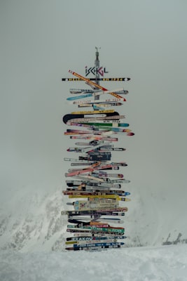 Ischgl's famous signpost built from dozens of colourful old skis, standing on the snow-covered mountain