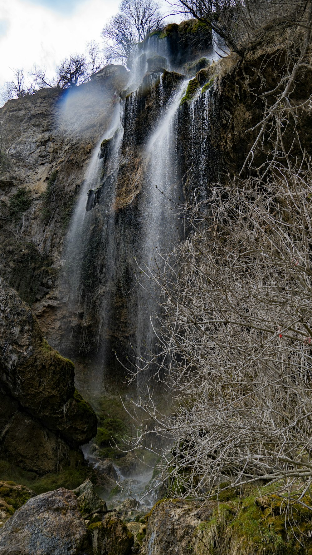 a very tall waterfall with lots of water coming out of it