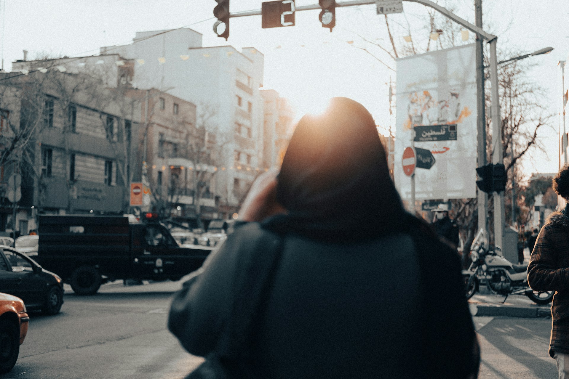 a woman standing in the middle of a busy street