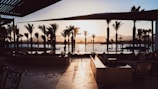 A quiet lounge area with comfortable seating overlooking a golden sunset.