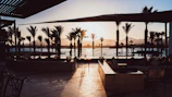 Sunset view of the terrace with warm lighting and cozy seating.