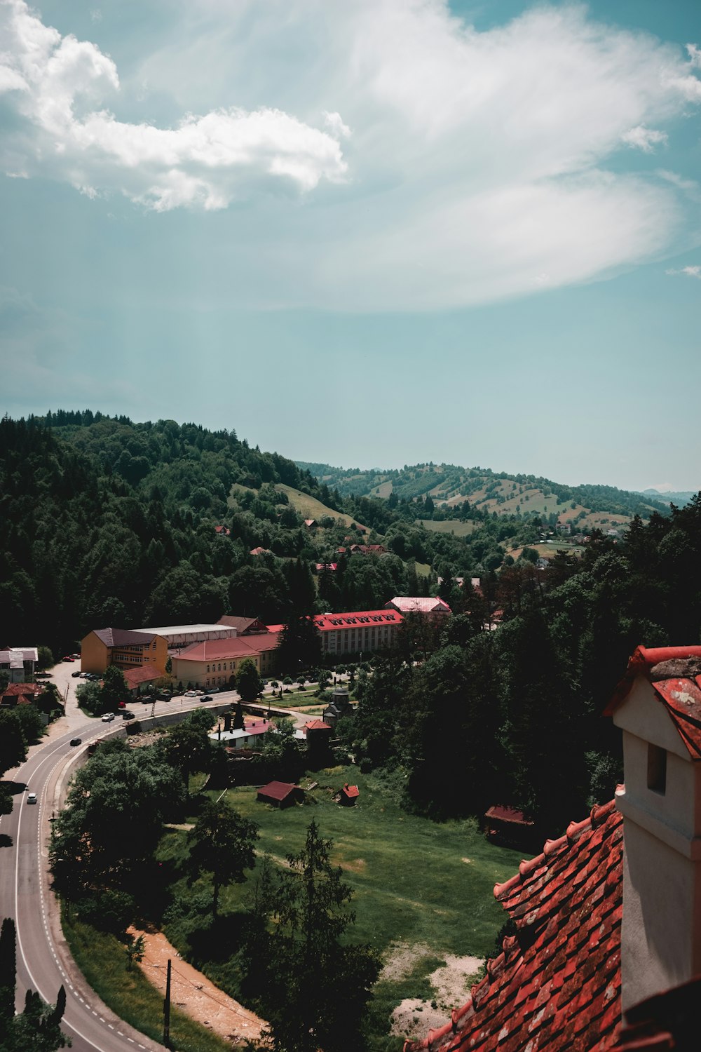 a scenic view of a town with a winding road