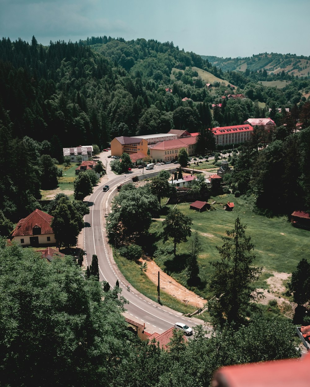 a scenic view of a town surrounded by trees