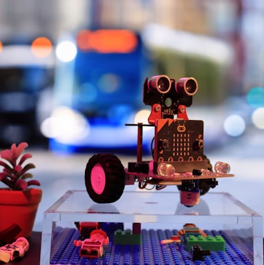 a toy robot is sitting on a table next to a traffic light