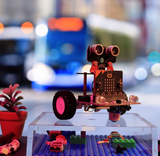 a toy robot is sitting on a table next to a traffic light