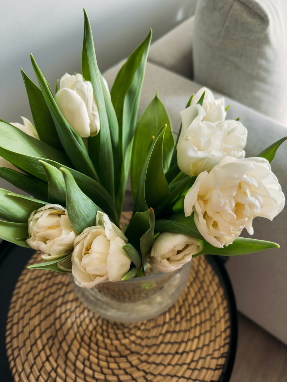 a vase filled with white flowers on top of a table