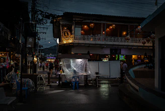 a group of people standing outside of a building at night