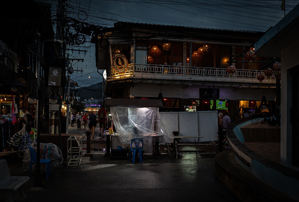 a group of people standing outside of a building at night