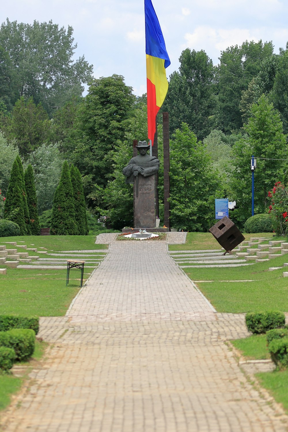 a large flag is flying in a park