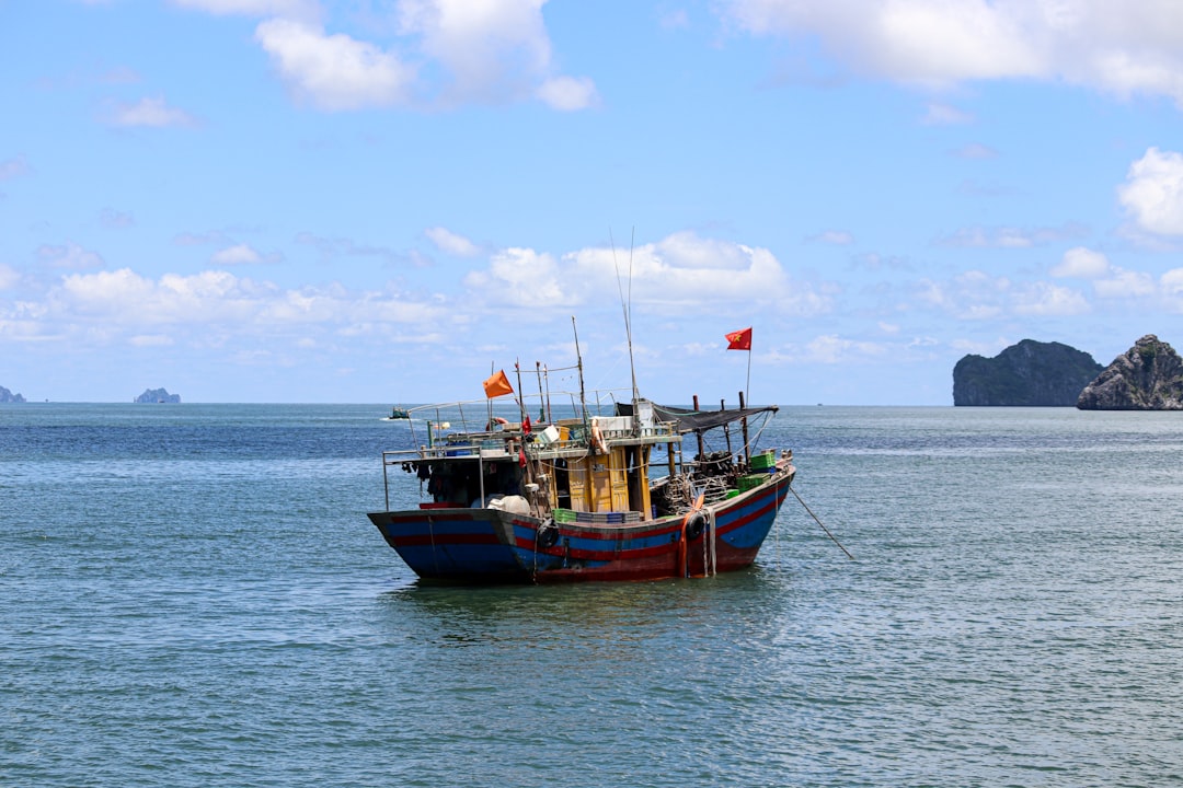 a boat floating on top of a large body of water, Lonely fisherman