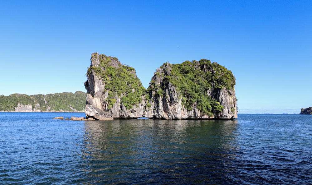 a group of rocks in the middle of a body of water