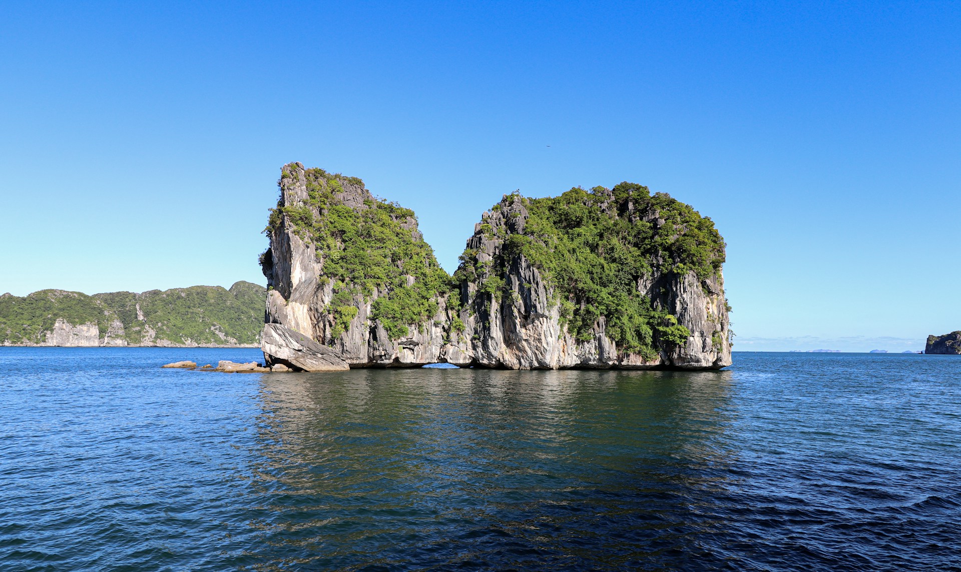 a group of rocks in the middle of a body of water