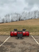 Snow removal equipment clearing a warehouse parking lot under a clear Vancouver sky.