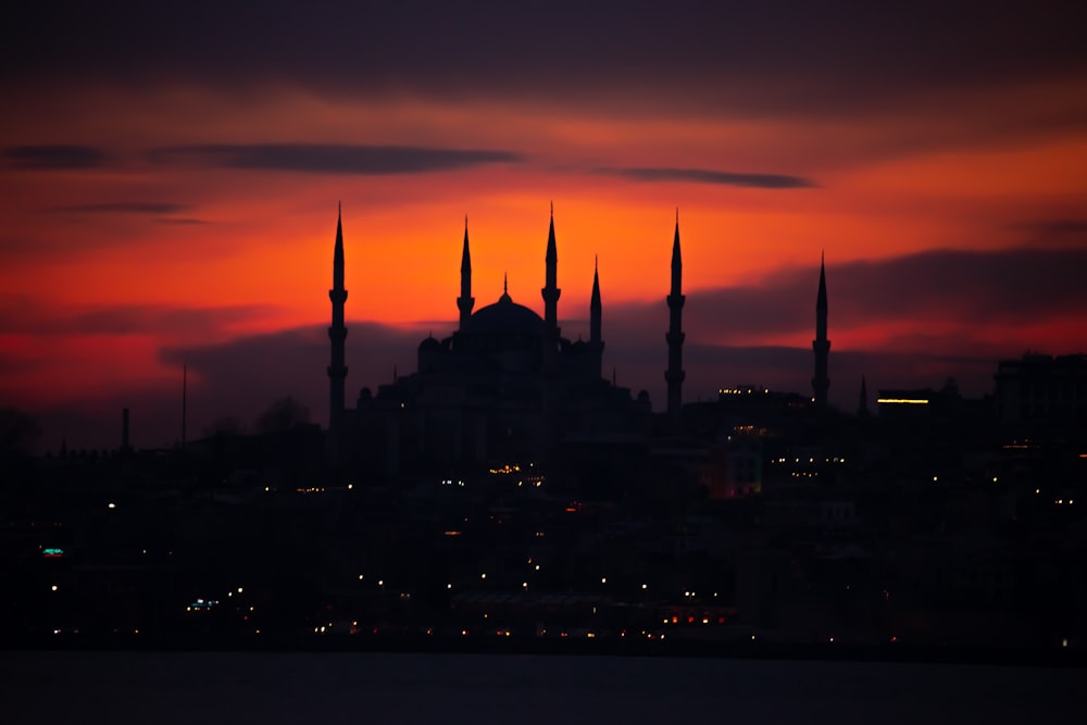 a sunset view of a large building with many spires