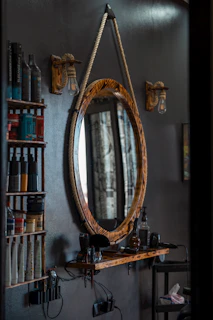 A stylish mirror framed with warm LED lights illuminating a clean, modern barber station.