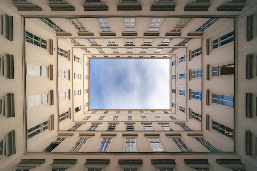 a very tall building with windows and a sky view