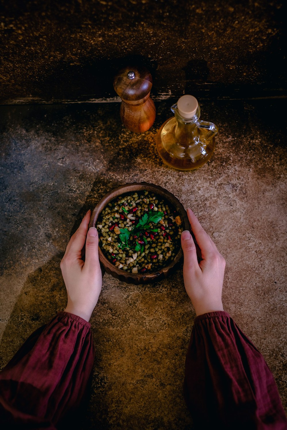 a person holding a bowl of food on a table