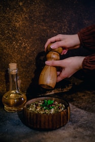 An artisan carefully grinding spices by hand, capturing the essence of 50 years of authentic taste.