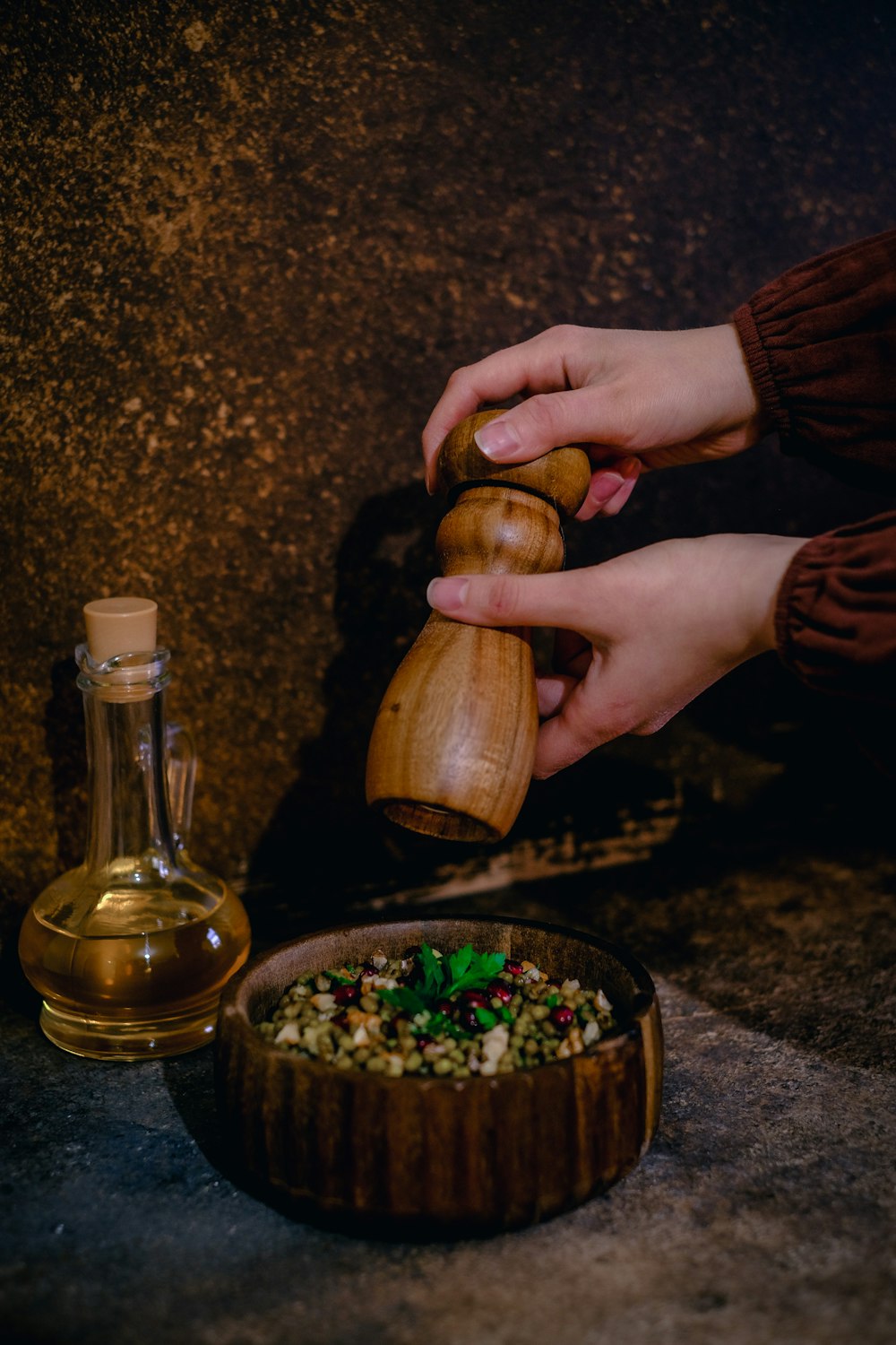 a person is pouring olives into a bowl