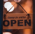 a wooden sign hanging from the side of a window