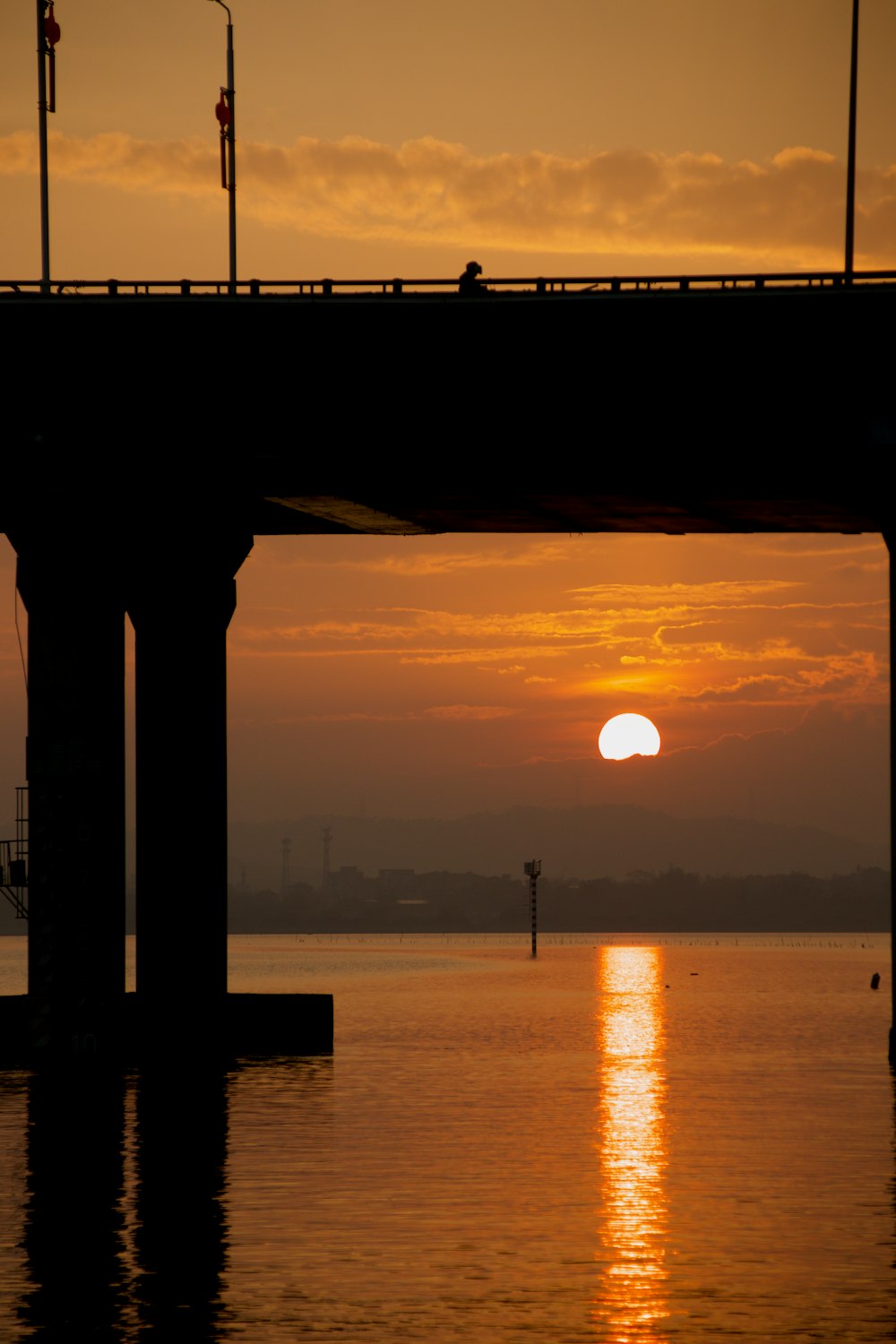 a bridge over a body of water at sunset