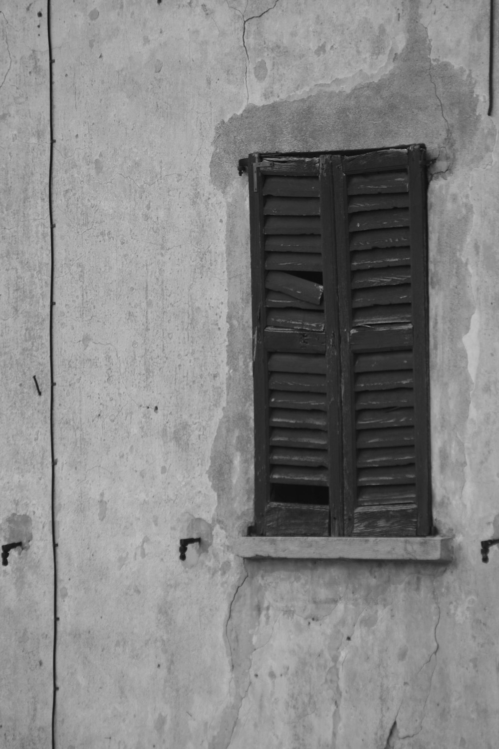 a black and white photo of a window on a wall