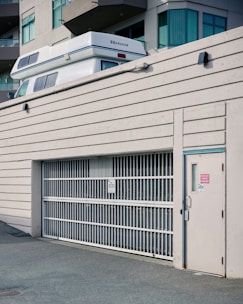 A sleek moving truck parked outside a modern Okanagan home at sunrise.