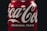 A close-up of a refreshing energy drink can with condensation on a wooden table.