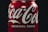 A close-up of a refreshing energy drink can with condensation on a wooden table.