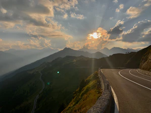 A mountain road at sunrise symbolizing the narrow path of faith.