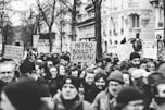a large group of people holding signs in the street